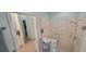 Bathroom with walk-in shower, glass door, built-in safety features, and storage at 8980 Se 176Th Limerick Ln, The Villages, FL 32162