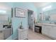Bathroom with blue walls, tile floors, and vanity with white cabinets at 8980 Se 176Th Limerick Ln, The Villages, FL 32162