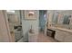 Bathroom featuring tiled floors, vanity area, and a large mirror for a clean look at 8980 Se 176Th Limerick Ln, The Villages, FL 32162
