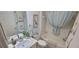 Well-lit bathroom features a shower-tub combination with a decorative shower curtain at 8980 Se 176Th Limerick Ln, The Villages, FL 32162