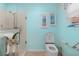 Modern toilet with a bidet next to a glass shower accented by calming beach artwork at 8980 Se 176Th Limerick Ln, The Villages, FL 32162