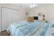 Cozy bedroom featuring a comfortable bed, closet, and bright natural light at 8980 Se 176Th Limerick Ln, The Villages, FL 32162