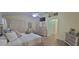 Spacious bedroom featuring wood-look floors, ceiling fan, TV, and dresser with a mirror at 8980 Se 176Th Limerick Ln, The Villages, FL 32162