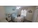 Comfortable bedroom with light blue decor, ceiling fan and lots of natural light at 8980 Se 176Th Limerick Ln, The Villages, FL 32162