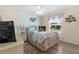 Bedroom featuring wood-look floors, coastal decor, and a sunlit window at 8980 Se 176Th Limerick Ln, The Villages, FL 32162