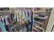 Walk-in closet with ample storage space, shelving and hanging rods for organization at 8980 Se 176Th Limerick Ln, The Villages, FL 32162
