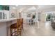 Open-concept dining room with a decorative chandelier and stylish bar seating at 8980 Se 176Th Limerick Ln, The Villages, FL 32162