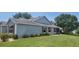 Well-maintained home exterior with manicured lawn, lush landscaping, and screened-in porch; a great outdoor space at 8980 Se 176Th Limerick Ln, The Villages, FL 32162
