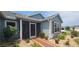 Beautiful home exterior with well-manicured landscaping and a charming screened-in porch at 8980 Se 176Th Limerick Ln, The Villages, FL 32162