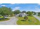 Wide angle view of a well maintained home with beautiful landscaping in a suburban neighborhood at 8980 Se 176Th Limerick Ln, The Villages, FL 32162