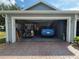 Spacious two-car garage with room for a golf cart and ample storage, plus a brick paver driveway at 8980 Se 176Th Limerick Ln, The Villages, FL 32162