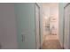 Bright hallway with tile floors leading to the bathroom with neutral paint colors at 8980 Se 176Th Limerick Ln, The Villages, FL 32162