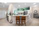 Modern kitchen with breakfast bar seating, stainless steel appliances, and natural light at 8980 Se 176Th Limerick Ln, The Villages, FL 32162