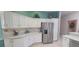 Spacious kitchen features white cabinetry, stainless steel refrigerator and lots of counter space at 8980 Se 176Th Limerick Ln, The Villages, FL 32162