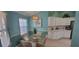 Bright eat-in kitchen features a glass table, white cabinetry and stainless steel appliances at 8980 Se 176Th Limerick Ln, The Villages, FL 32162