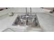 Stainless steel kitchen sink with dual basins and modern faucet at 8980 Se 176Th Limerick Ln, The Villages, FL 32162