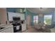 Bright kitchen with stainless steel appliances and adjacent breakfast nook at 8980 Se 176Th Limerick Ln, The Villages, FL 32162