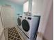 Laundry room equipped with modern washer and dryer, complemented by ample cabinet space at 8980 Se 176Th Limerick Ln, The Villages, FL 32162