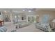 Open concept living room with tiled floors, comfortable seating, and access to the dining area at 8980 Se 176Th Limerick Ln, The Villages, FL 32162
