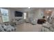 Bright living room with tile flooring, neutral paint, comfortable seating, and large windows at 8980 Se 176Th Limerick Ln, The Villages, FL 32162