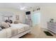 Relaxing bedroom with wood-look floors, neutral tones, and a comfortable bed with a ceiling fan at 8980 Se 176Th Limerick Ln, The Villages, FL 32162