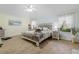 Serene main bedroom featuring wood-look floors, ceiling fan, and natural light at 8980 Se 176Th Limerick Ln, The Villages, FL 32162