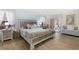 Comfortable main bedroom with wood-look floors, ceiling fan, and a sliding glass door to the patio at 8980 Se 176Th Limerick Ln, The Villages, FL 32162