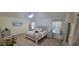 Tranquil main bedroom with a large bed, neutral tones, and natural light at 8980 Se 176Th Limerick Ln, The Villages, FL 32162