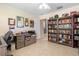 Office space showcasing tile flooring and a large bookcase, perfect for organization at 8980 Se 176Th Limerick Ln, The Villages, FL 32162