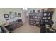 Home office features a work space, built in bookcases and neutral walls at 8980 Se 176Th Limerick Ln, The Villages, FL 32162