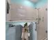 An accessible walk-in shower with grab bars, a rain shower head and handheld shower at 8980 Se 176Th Limerick Ln, The Villages, FL 32162