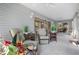 Well-lit sunroom with tile floors and comfortable seating offering relaxing views at 8980 Se 176Th Limerick Ln, The Villages, FL 32162