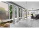 Large sunroom featuring tile floors and walls of windows providing natural light at 8980 Se 176Th Limerick Ln, The Villages, FL 32162