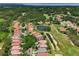 Beautiful aerial view of community homes, mature trees, and ponds at 9307 San Jose Blvd, Howey In The Hills, FL 34737