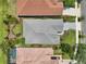 Aerial view of the house showcasing the roof, pool and landscaped lawn at 9307 San Jose Blvd, Howey In The Hills, FL 34737