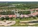 Beautiful aerial view of homes and golf course in a lush green community at 9307 San Jose Blvd, Howey In The Hills, FL 34737