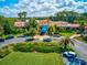 Aerial view of a building with tropical landscaping, surrounding greenery, and parking at 9307 San Jose Blvd, Howey In The Hills, FL 34737