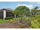 Well-maintained backyard with green grass, mature trees and a view of the home's screened-in porch at 9307 San Jose Blvd, Howey In The Hills, FL 34737