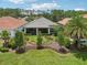 Charming backyard with lush landscaping and a screened in lanai at 9307 San Jose Blvd, Howey In The Hills, FL 34737