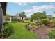 A lush backyard with manicured lawn, mature trees and a view of the screened-in pool area at 9307 San Jose Blvd, Howey In The Hills, FL 34737