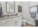 Bright bathroom featuring a white vanity, modern mirror, and neutral finishes at 9307 San Jose Blvd, Howey In The Hills, FL 34737