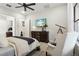 Primary bedroom featuring a large window, accent furniture, and neutral finishes at 9307 San Jose Blvd, Howey In The Hills, FL 34737