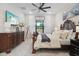 A luxurious main bedroom features a beautiful wood bed frame, soft carpet, and a flat screen TV at 9307 San Jose Blvd, Howey In The Hills, FL 34737