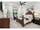 Primary bedroom featuring a large window, accent furniture, and wood furnishings at 9307 San Jose Blvd, Howey In The Hills, FL 34737