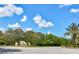 Welcoming entrance to the Las Colinas community with lush landscaping at 9307 San Jose Blvd, Howey In The Hills, FL 34737