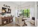 Charming dining area with natural light, wood floors, and stylish decor creates a cozy ambiance at 9307 San Jose Blvd, Howey In The Hills, FL 34737
