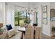 Elegant dining room with chandelier, view of the landscaped yard, and comfortable seating at 9307 San Jose Blvd, Howey In The Hills, FL 34737