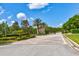 Private gated entrance to the community with well-maintained landscaping at 9307 San Jose Blvd, Howey In The Hills, FL 34737