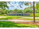 Scenic view of the golf course featuring a stone bridge over a pond at 9307 San Jose Blvd, Howey In The Hills, FL 34737