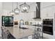 Modern kitchen with a large island, pendant lighting, and stainless steel appliances at 9307 San Jose Blvd, Howey In The Hills, FL 34737